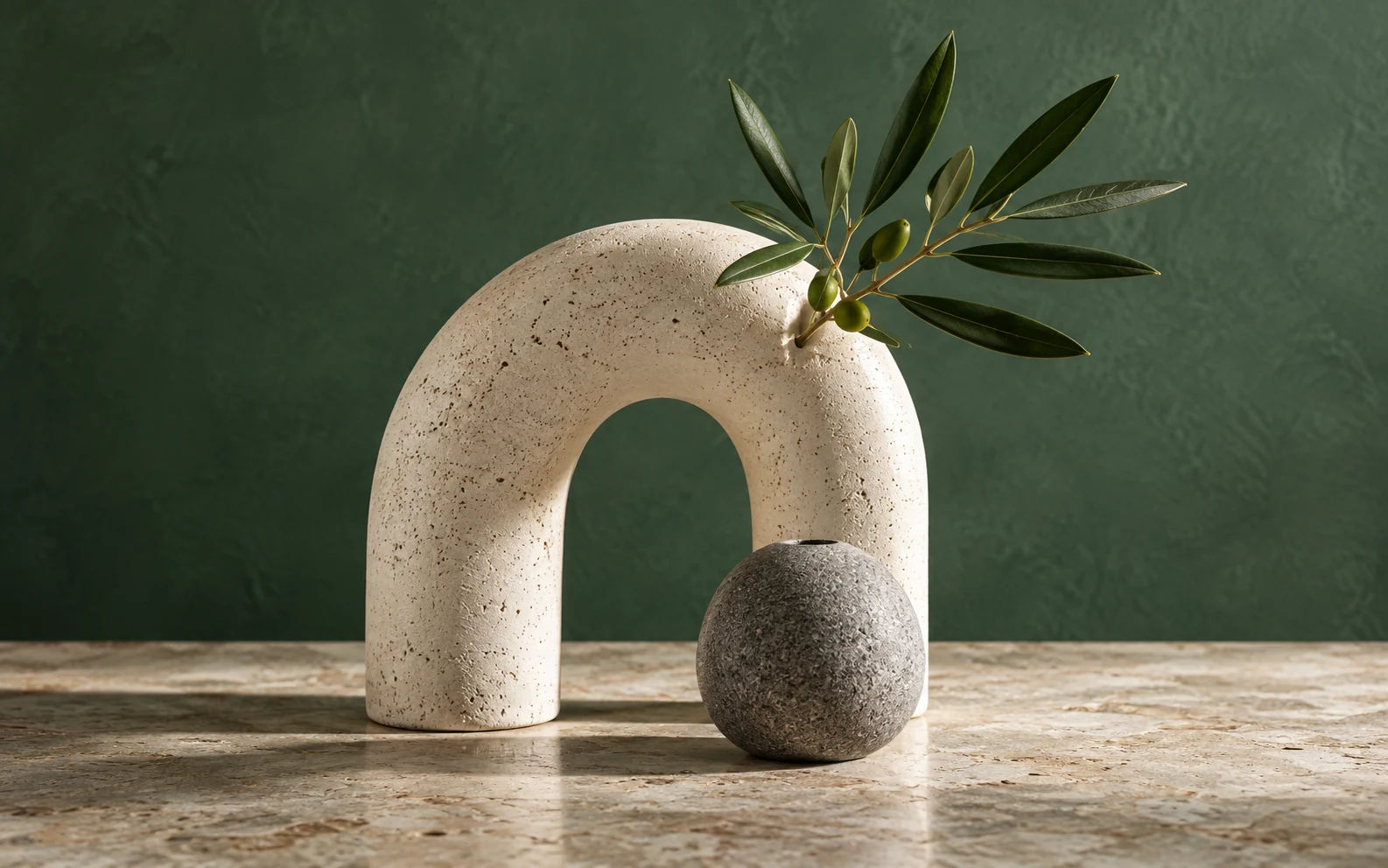 Ceramic vases with an olive branch on a stone surface